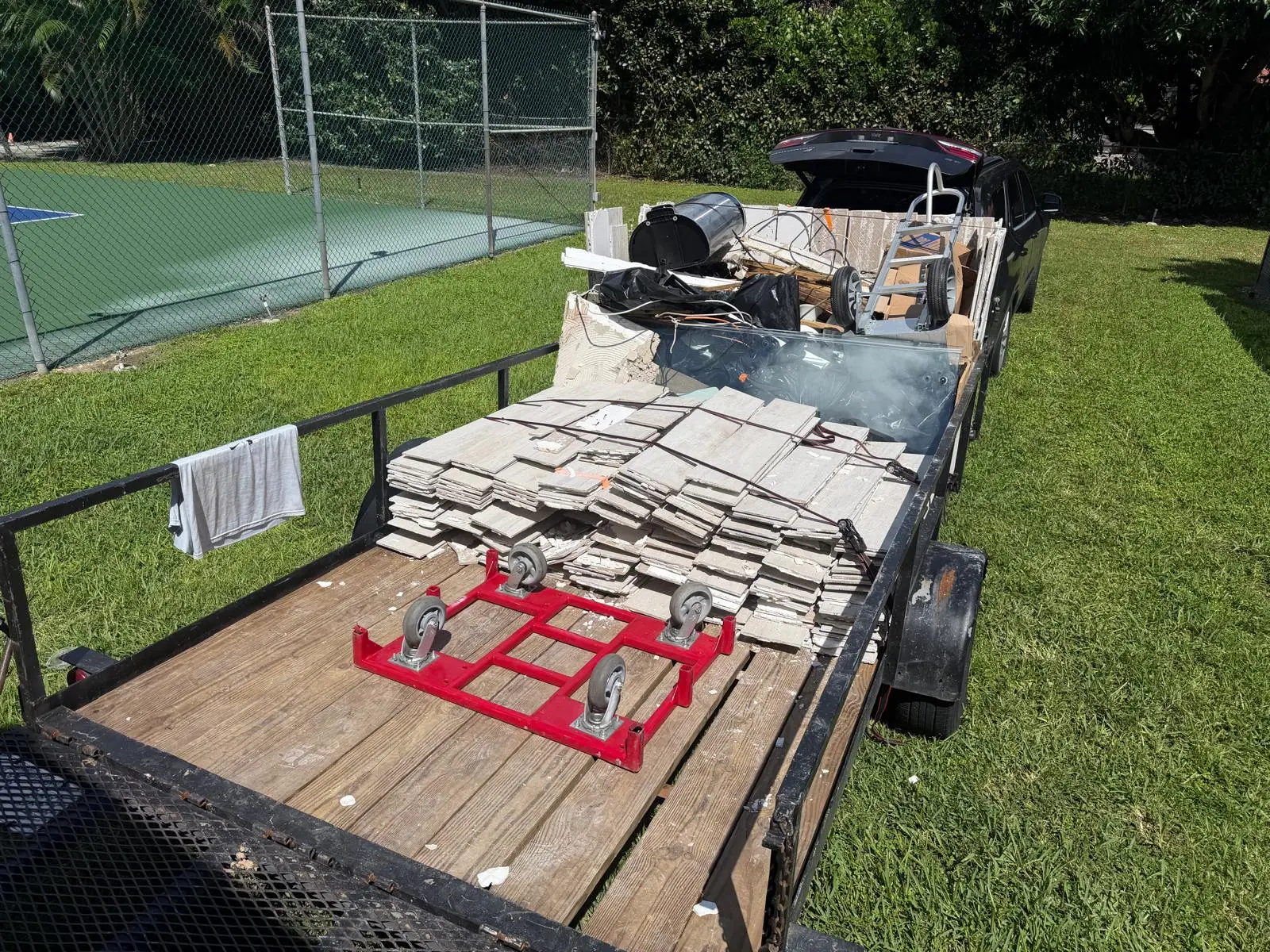 Utility trailer loaded with construction and renovation debris ready for hauling